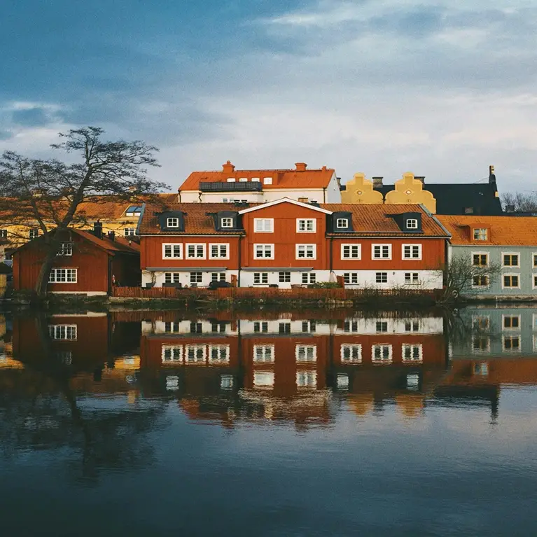 Image of the Swedish Stockholm skyline, including historic buildings and waterways, in the background.